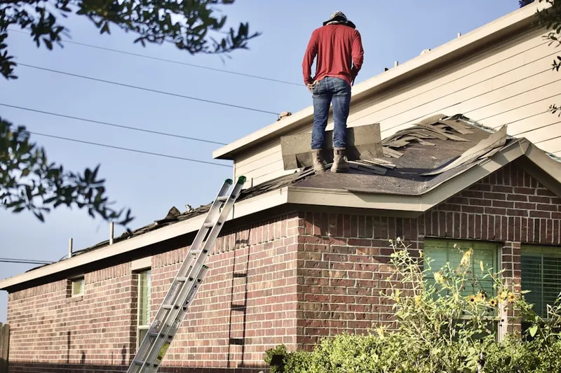 Professional roofer working on a residential roof in Waterville